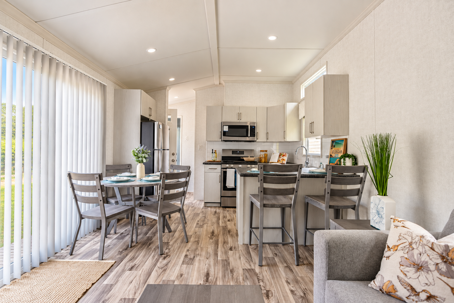 Inside a new seasonal cottage, looking across the living space to the kitchen